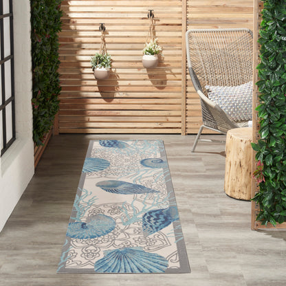 Tapis d'intérieur et d'extérieur Waverly Sun &amp; Shade Shore Thing à motif de coquillages tropicaux et floraux
